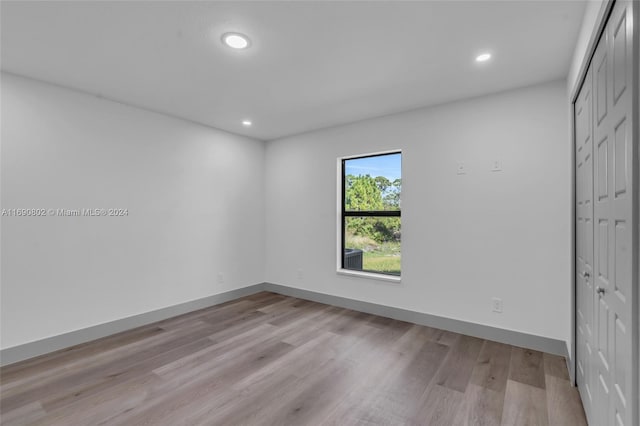 unfurnished bedroom with a closet and light hardwood / wood-style flooring