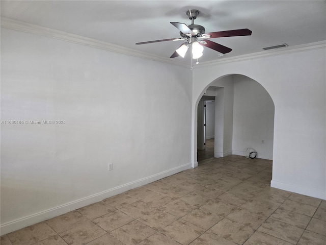 unfurnished room featuring ceiling fan and crown molding