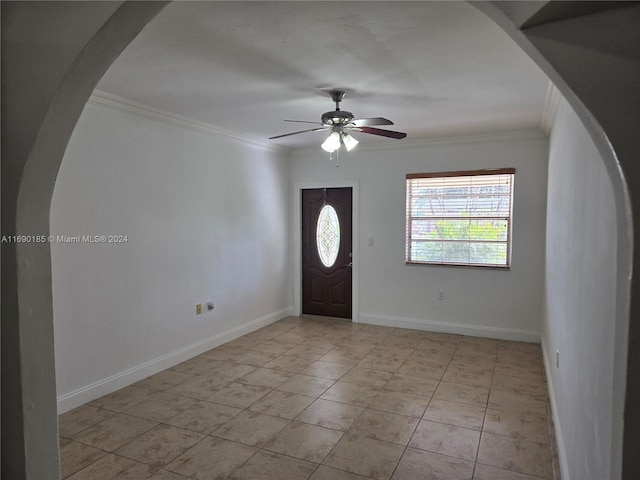 entrance foyer featuring ceiling fan and ornamental molding