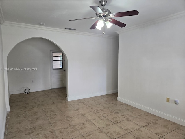 empty room with ceiling fan and crown molding