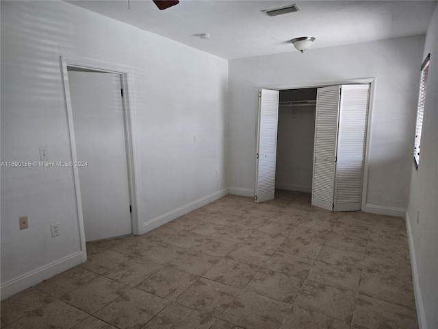 unfurnished bedroom featuring ceiling fan