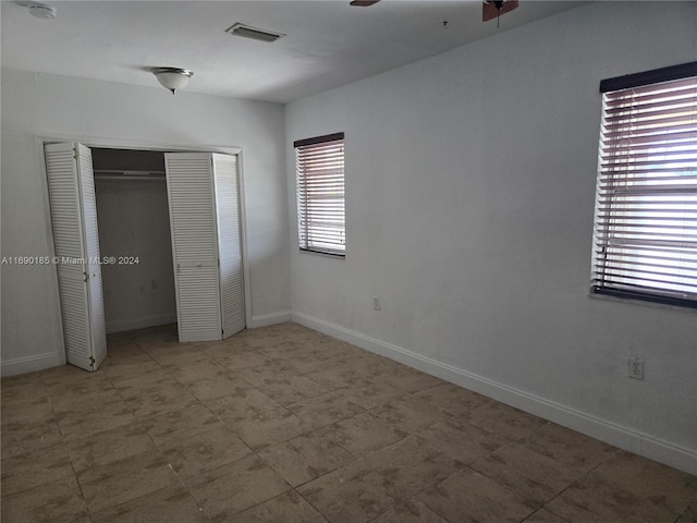 unfurnished bedroom featuring ceiling fan