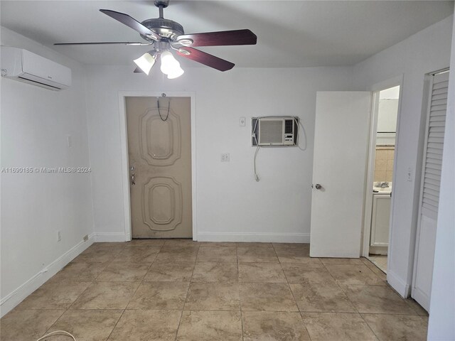 unfurnished bedroom featuring ceiling fan and an AC wall unit