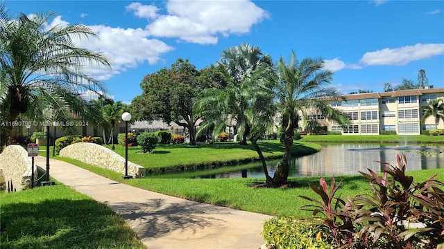 view of property's community featuring a yard and a water view