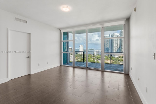 unfurnished room featuring floor to ceiling windows