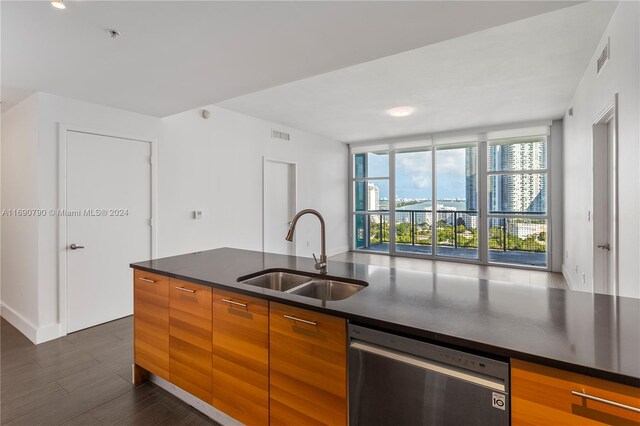 kitchen featuring dark wood-type flooring, a wall of windows, sink, and dishwasher