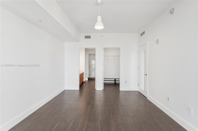 empty room featuring dark hardwood / wood-style flooring