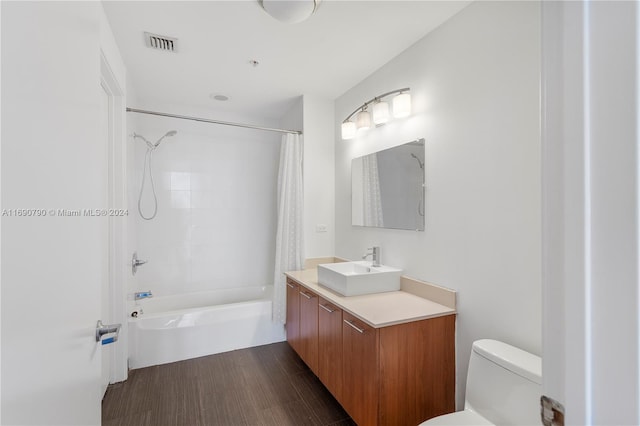 full bathroom with wood-type flooring, vanity, toilet, and shower / tub combo