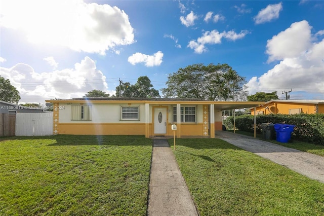 view of front of property with a front lawn and a carport