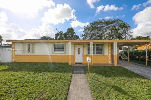 view of front facade with a front lawn and a carport