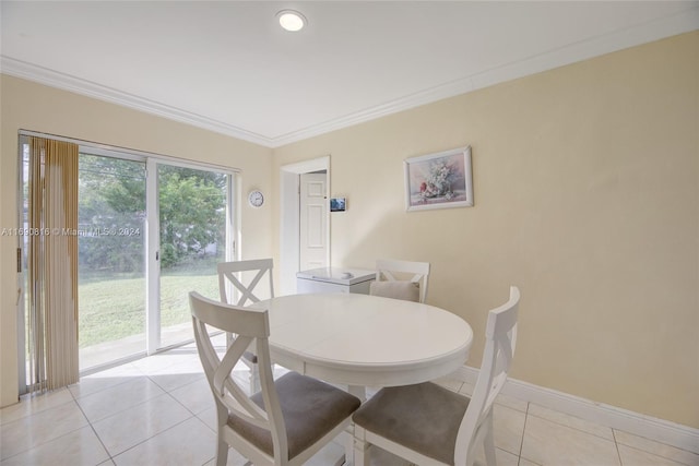 tiled dining area featuring crown molding