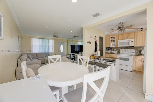 dining space with ornamental molding, light tile patterned floors, and ceiling fan