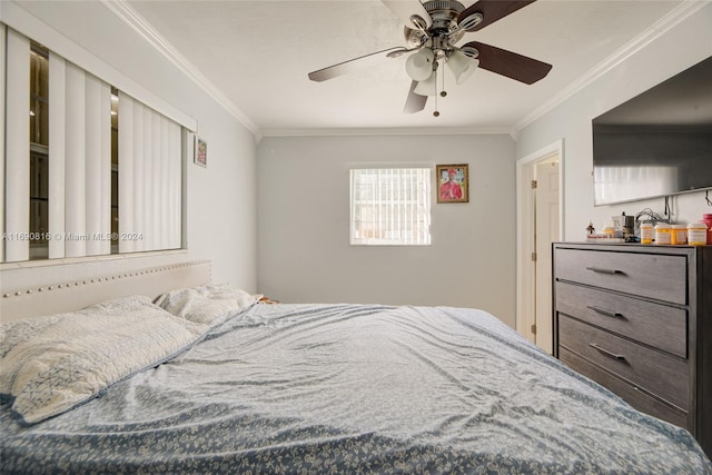 bedroom with ceiling fan and crown molding