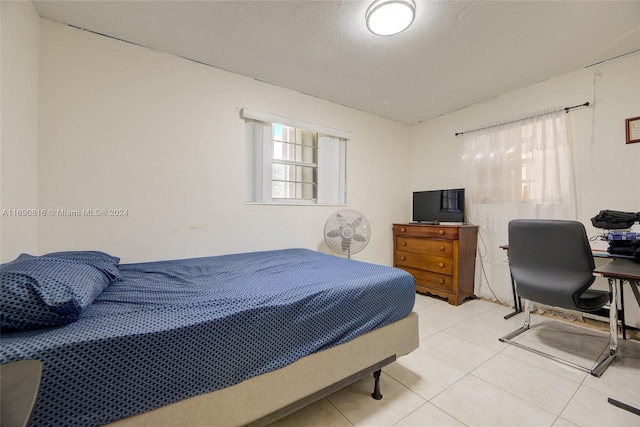 bedroom with light tile patterned floors