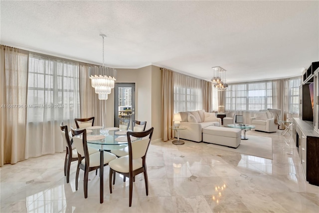 dining area with a notable chandelier and a textured ceiling