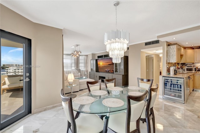 dining area with crown molding, beverage cooler, and a notable chandelier