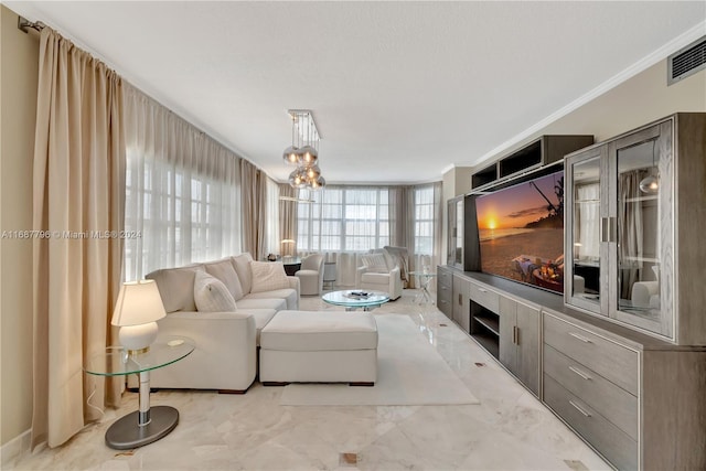 living room with a notable chandelier and crown molding