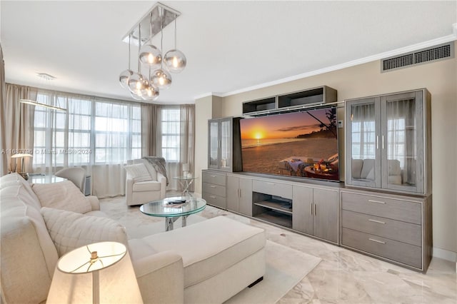 living room featuring a chandelier and ornamental molding