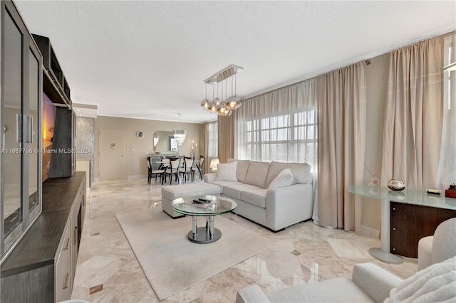 living room with a textured ceiling and a chandelier