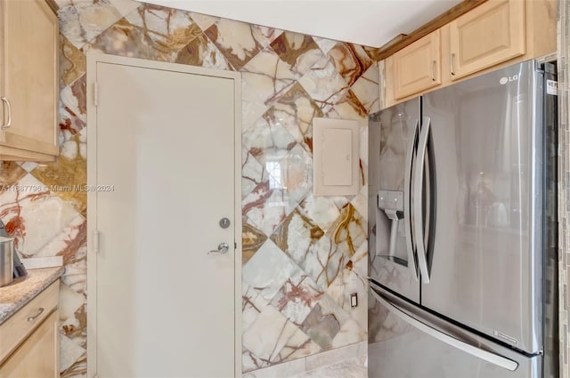 kitchen featuring stainless steel fridge with ice dispenser, light brown cabinets, and electric panel