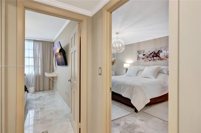 bedroom with ornamental molding and a chandelier