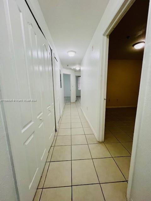 corridor with light tile patterned floors