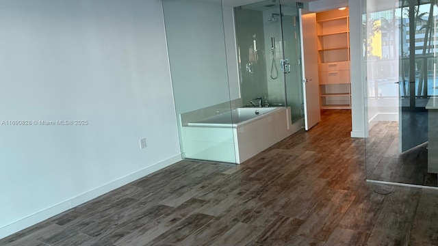 bathroom with hardwood / wood-style flooring and shower with separate bathtub