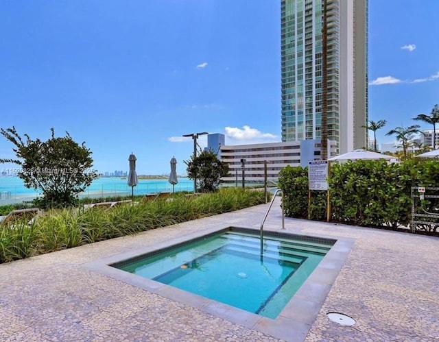view of pool featuring fence and a hot tub