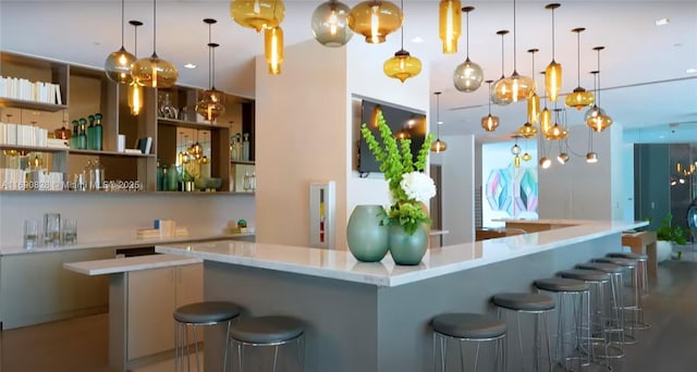 kitchen with a spacious island, a kitchen breakfast bar, and decorative light fixtures