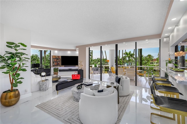 living room with floor to ceiling windows, a textured ceiling, and light tile patterned flooring