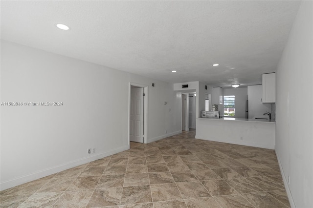 unfurnished living room with a textured ceiling