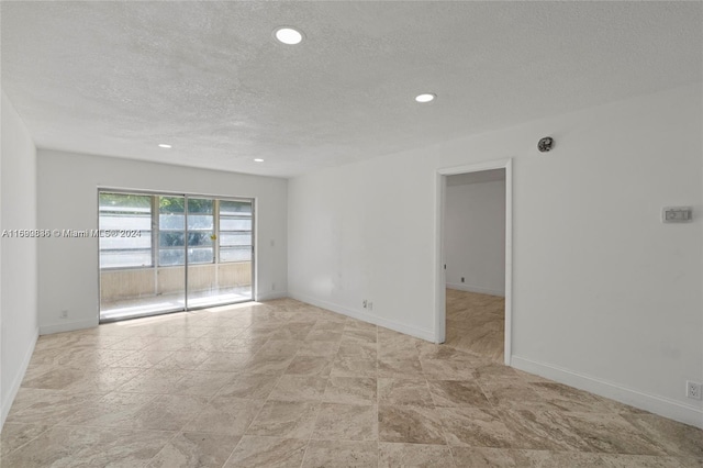 spare room with a textured ceiling