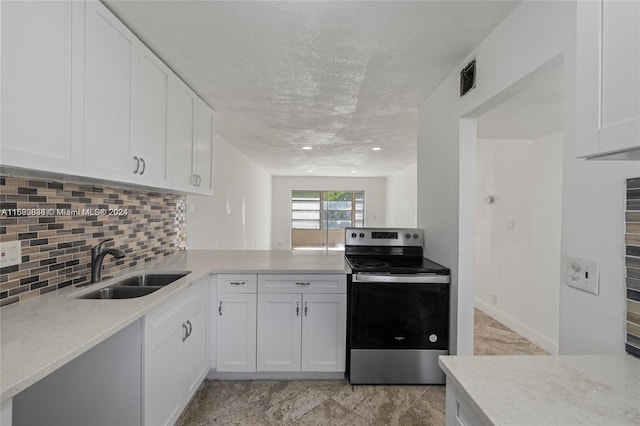 kitchen with white cabinets, stainless steel electric stove, and sink