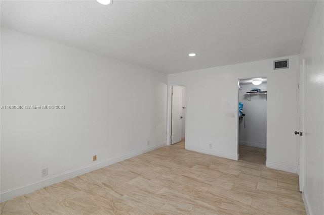 110 Lake Meryl Dr Unit 213, West Palm Beach, FL 33411 - unfurnished bedroom with recessed lighting, a walk in closet, baseboards, and a closet