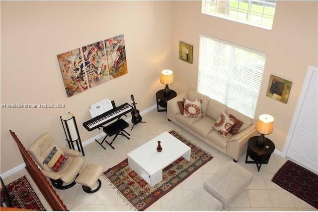 living room featuring tile patterned flooring and a towering ceiling