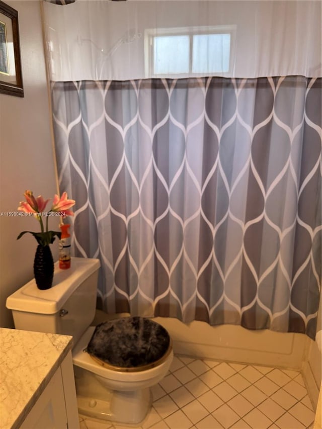 full bathroom with toilet, shower / tub combo, vanity, and tile patterned flooring