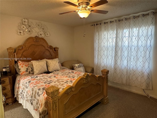 bedroom with a textured ceiling, carpet flooring, and ceiling fan