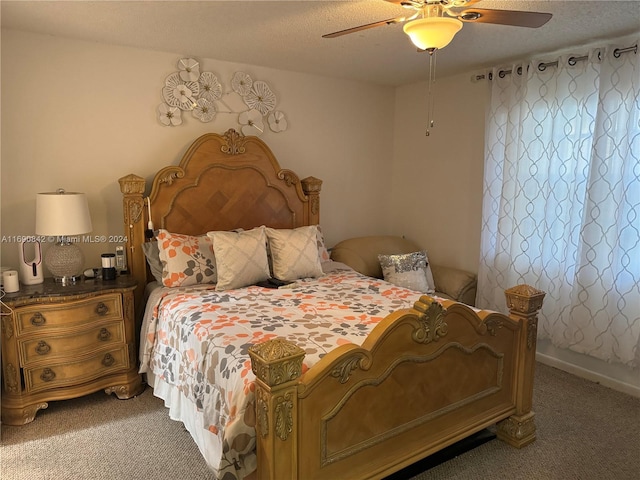 carpeted bedroom featuring a textured ceiling and ceiling fan