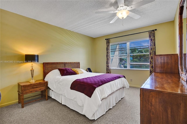 carpeted bedroom with a textured ceiling and ceiling fan