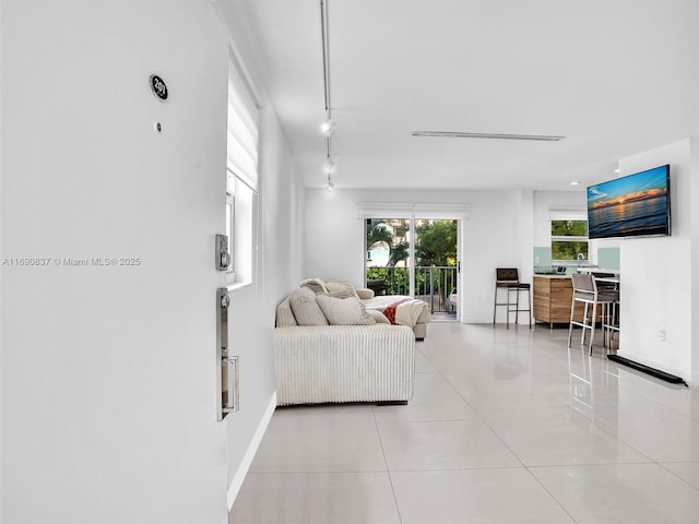 tiled living room featuring track lighting