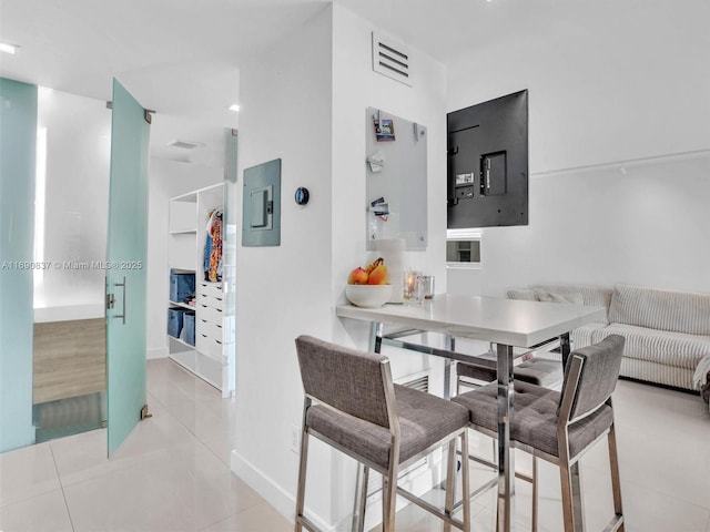 dining area featuring light tile patterned floors