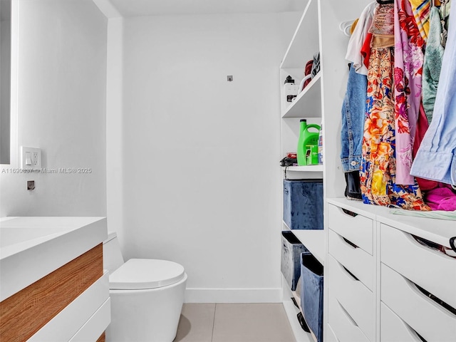 bathroom with tile patterned flooring and toilet