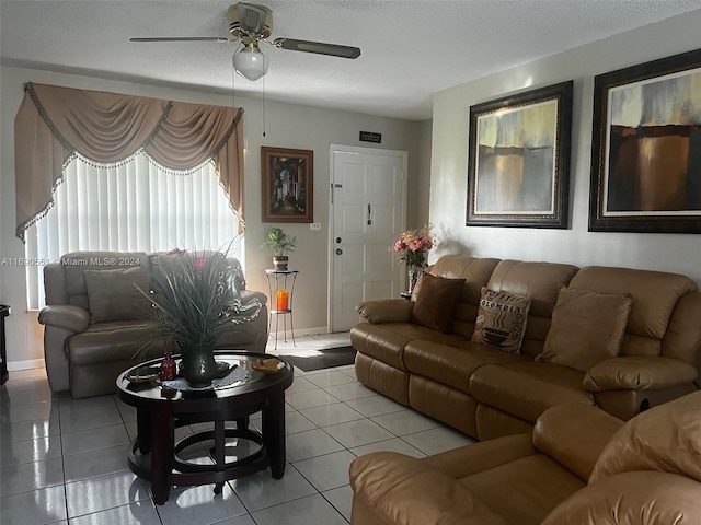 tiled living room featuring ceiling fan and a textured ceiling