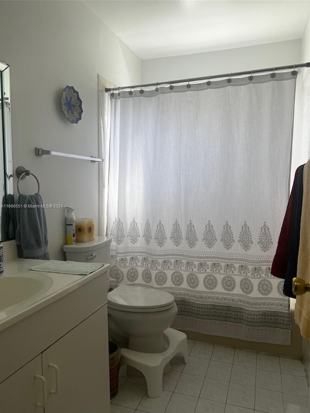 bathroom with tile patterned flooring, vanity, toilet, and a shower with shower curtain