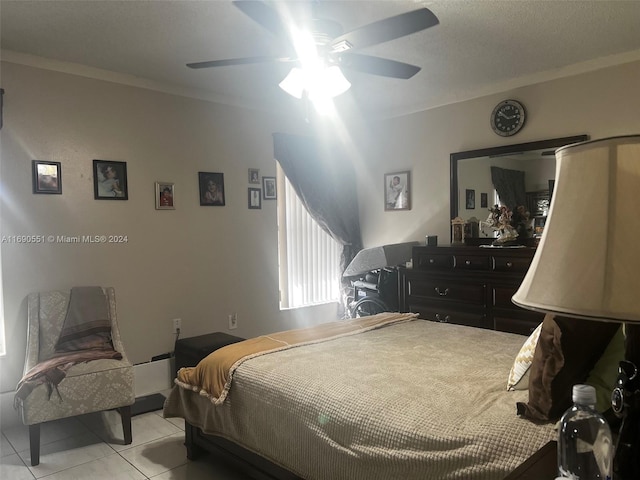 bedroom with ornamental molding, light tile patterned floors, and ceiling fan