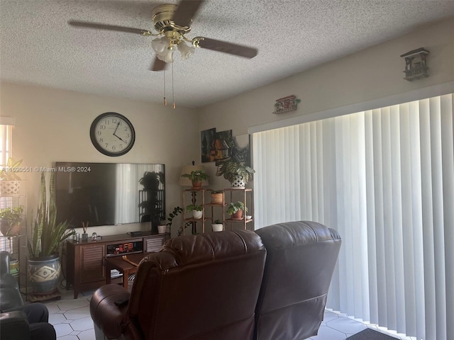 living room featuring a textured ceiling and ceiling fan
