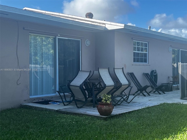 rear view of house with a yard and a patio area