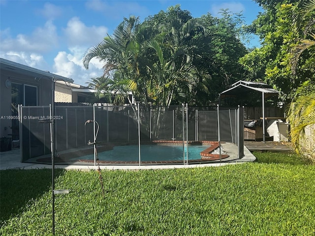view of pool featuring a lawn