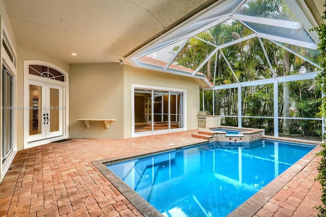 view of swimming pool featuring an in ground hot tub, a patio area, glass enclosure, and french doors