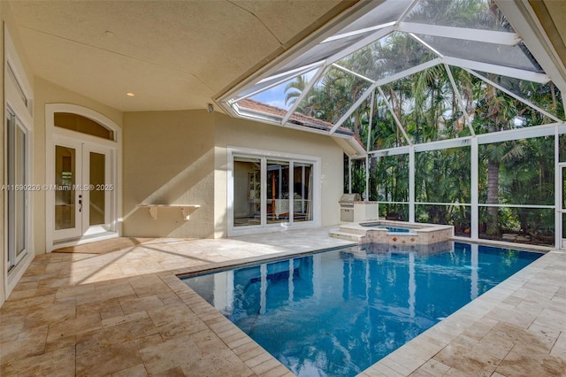 view of pool featuring glass enclosure, an in ground hot tub, french doors, and a patio